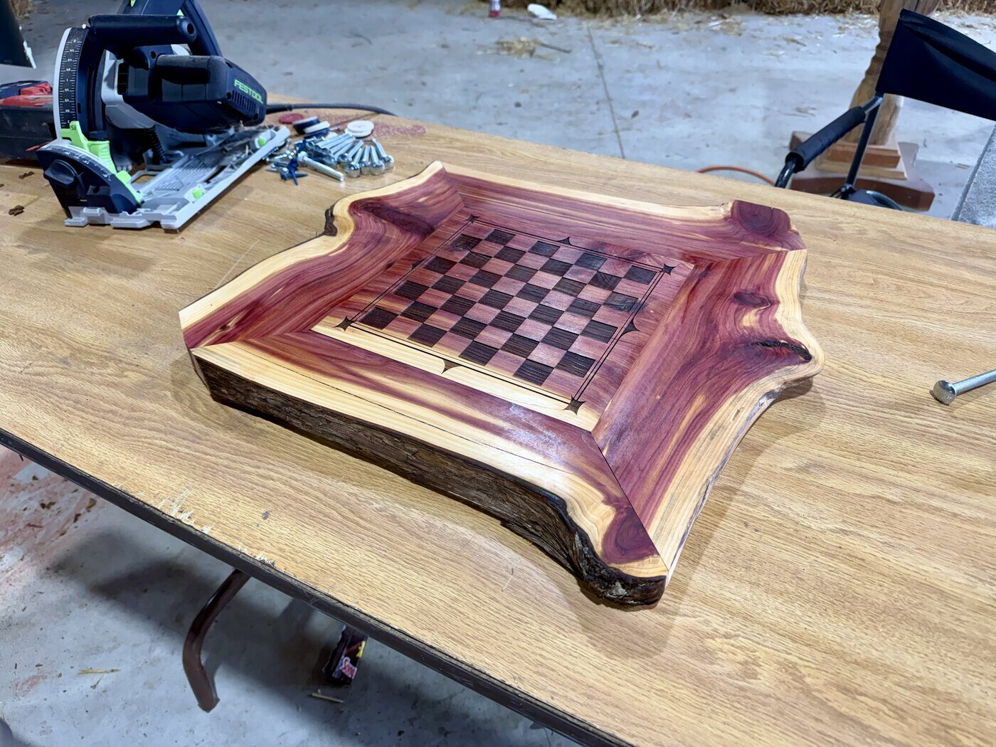 A live-edge eastern red cedar chess board with inlaid playing surface