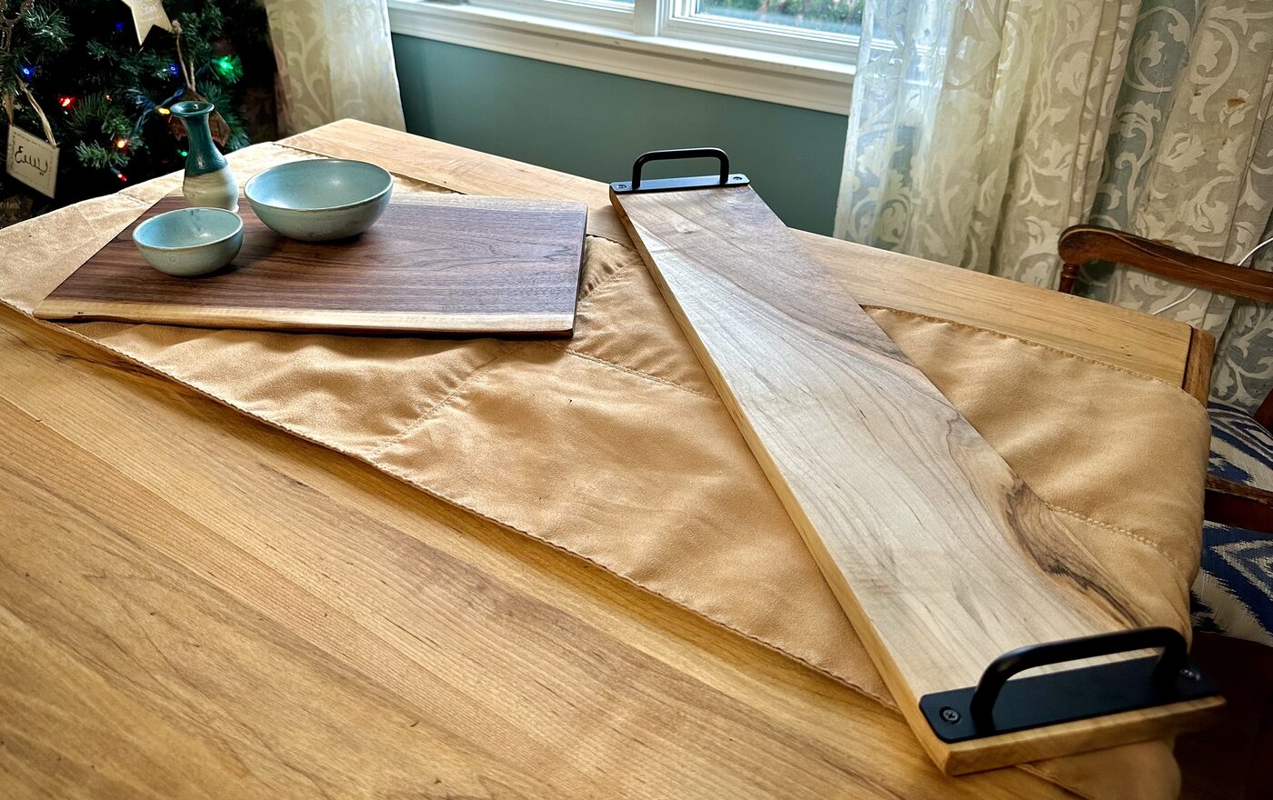 Live-edge walnut and ambrosia maple charcuterie boards with steel handles